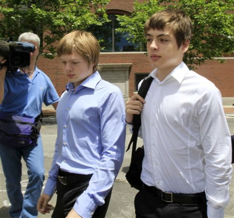Tim Foley, 20, left, and his brother Alex, 16, leave federal court after a bail hearing for their parents, Donald Heathfield and Tracey Lee Ann Foley, in Boston, on Thursday.